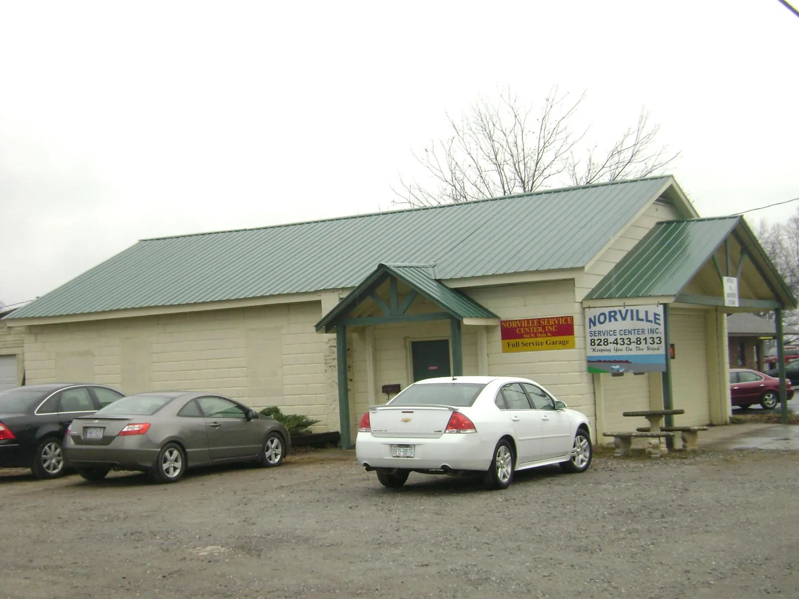 Green metal roof on a service garage with a covered entry in Braxton